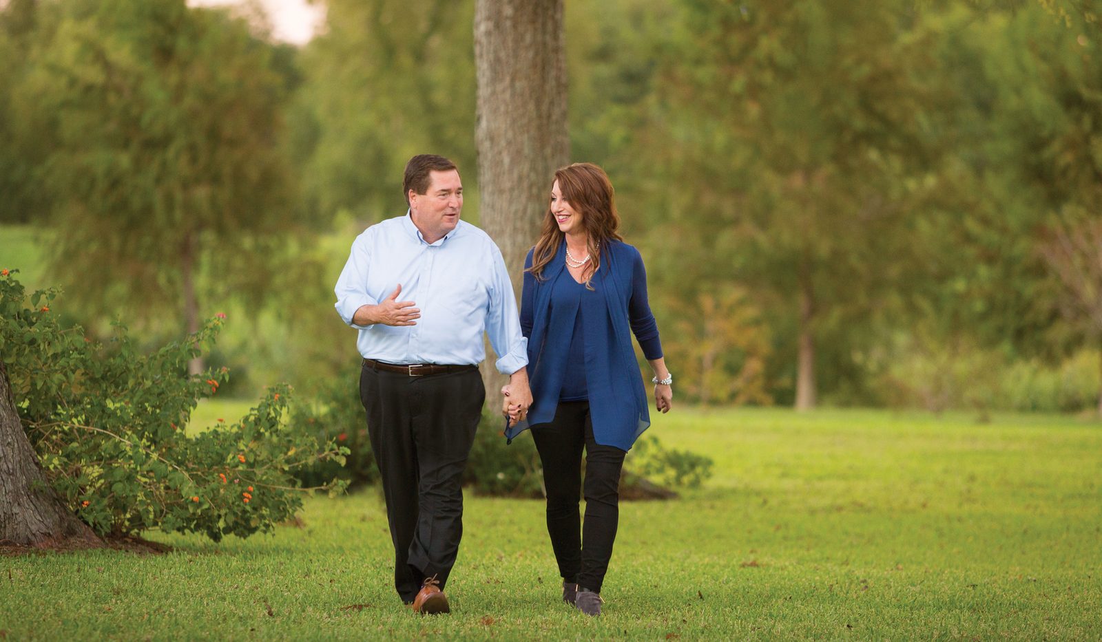 Billy and Cher Nungesser walking through a field